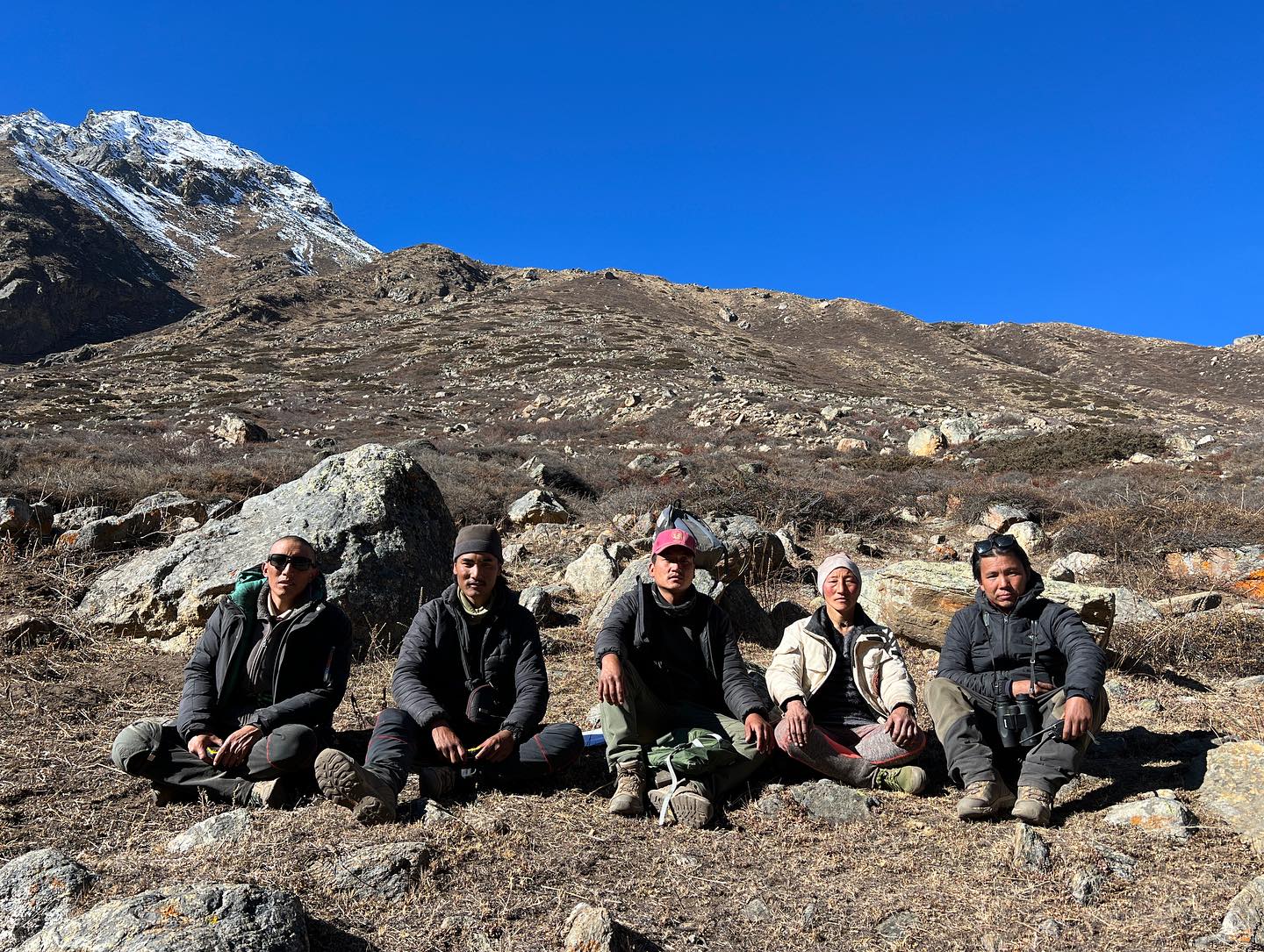 Community members in a capacity building and training session seated on the mountainside of Nepal’s Trans-Himalaya