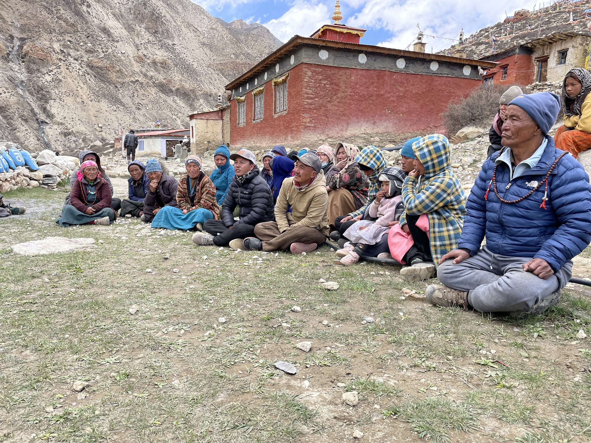 Village meeting with herders at Pho Village. A good snow leopard habitat can be seen in the background.