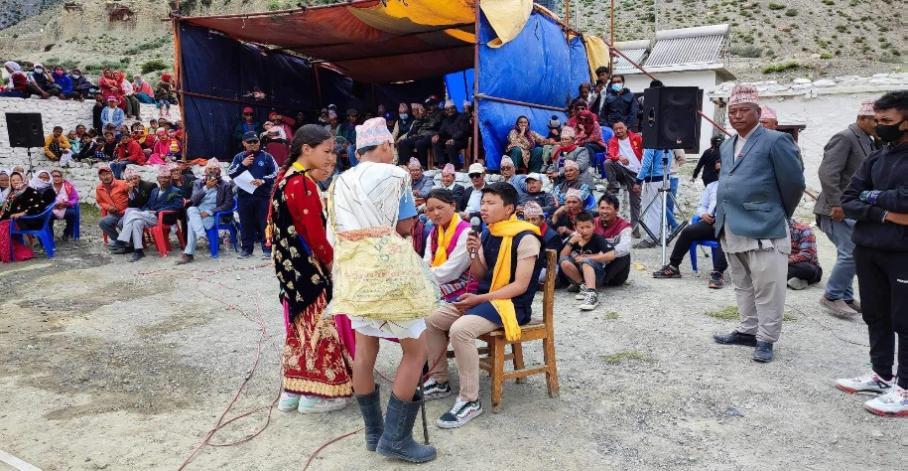 Photo of students performing a street drama to raise awareness about human-wildlife conflict mitigation and promoting coexistence with snow leopards in the Lower Mustang region of Nepal.