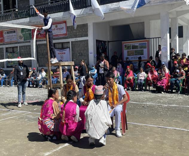 Photo of students performing a street drama to raise awareness about human-wildlife conflict mitigation and promoting coexistence with snow leopards in the Lower Mustang region of Nepal.