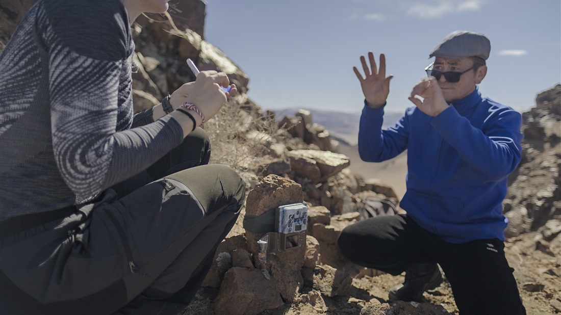 Photo of Wildlife Initiative team member setting up a trail camera in Mongolia