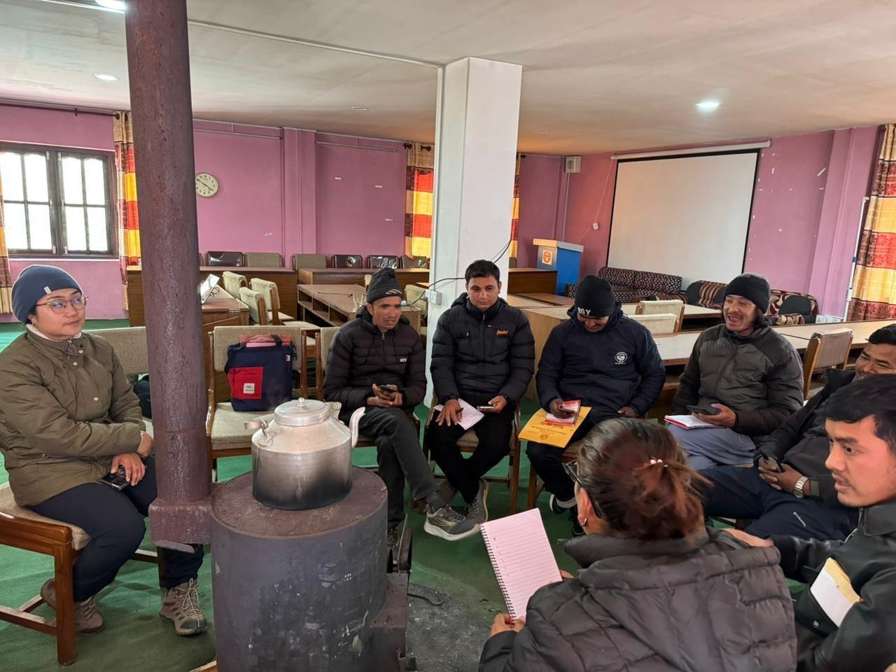 Vaccination clinic staff in Nepal gather to learn how to use a dog population census
